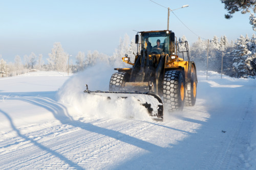 Forserum, Sweden - December, 26 2010: Snow removal using a Volvo Wheel Loader after a heavy snowfall.